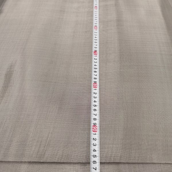 A tapeline is used to check the width of L605 woven mesh.
