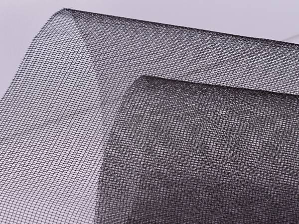 A roll of unfolded blackened wire mesh