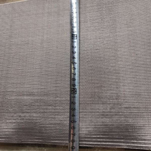 A tapeline is used to check the width of tantalum woven mesh.